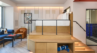 Interior view of the Executive Studio featuring an elevated king bed.