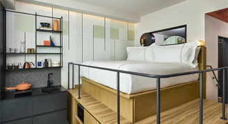 Interior view of the Mid Studio featuring an elevated king bed.