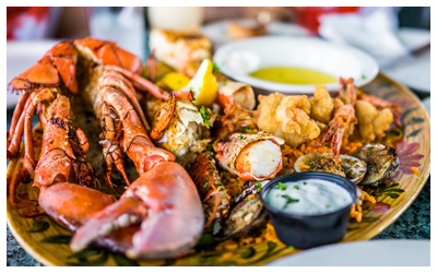 Cooked lobster, shrimp and crab on a plate