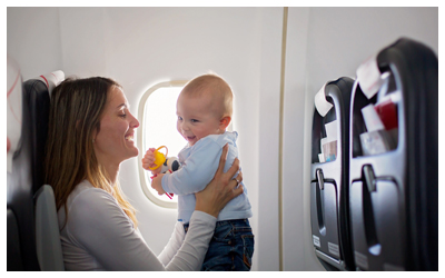 Image of a mother holding a baby on a plane