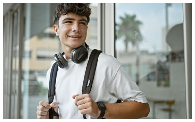 Image of a young teen with headphones and a backpack