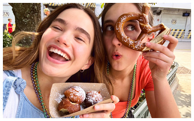 Guests enjoying powdered beignets and pretzel